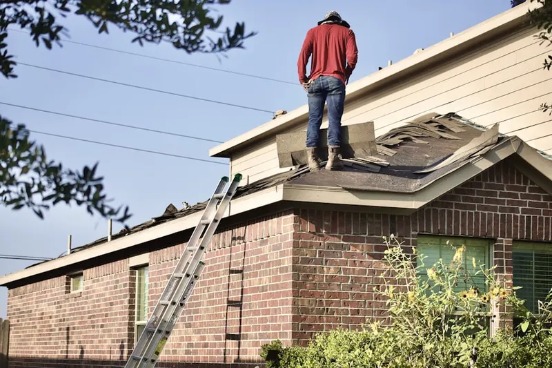 Professional roofer working on a residential roof in Churchville